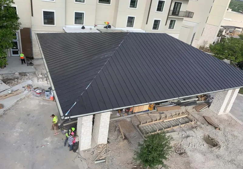 Metal roofing installation team working on a commercial building in Glen Ridge
