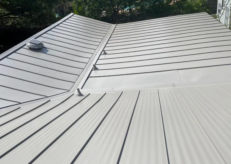 Solar attic fan installed on a metal roof for Roof Ventilation in Glen Ridge